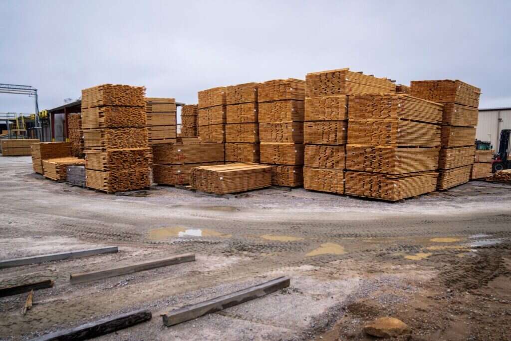 Piles of wooden planks prepared for distribution at an outdoor industrial site