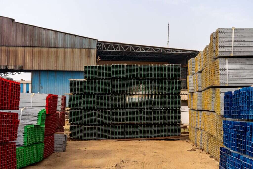 Stacks of industrial building materials organised in an outdoor storage yard