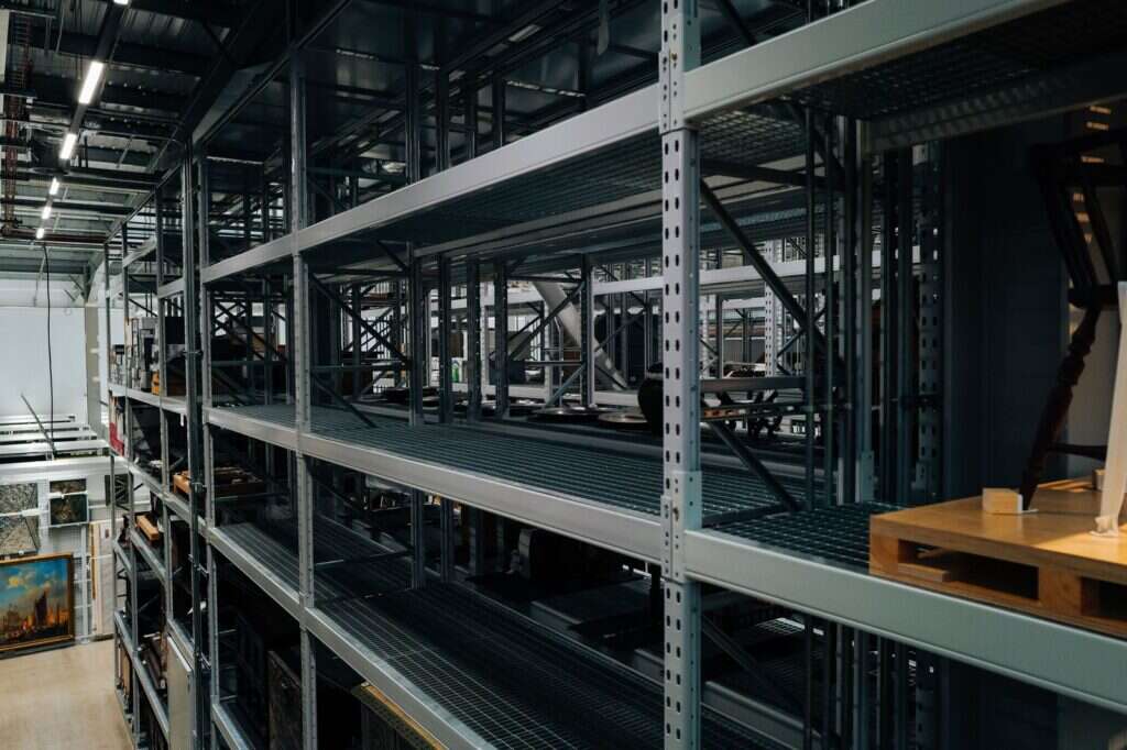 Tall metal storage racks inside a spacious industrial warehouse
