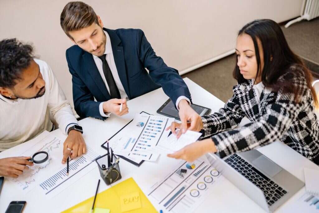 Business professionals reviewing charts and documents in a meeting
